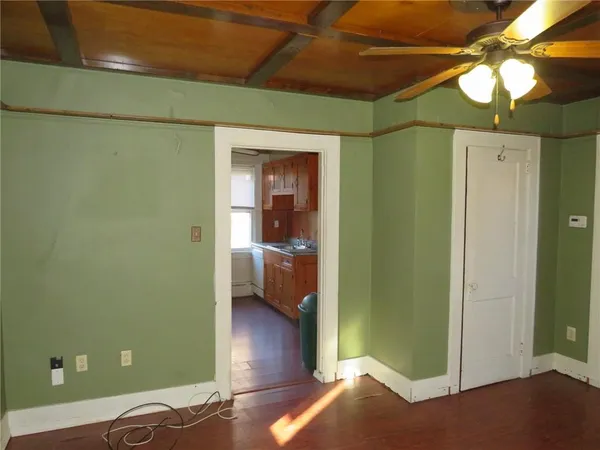 a view of a room with a furniture and a ceiling fan