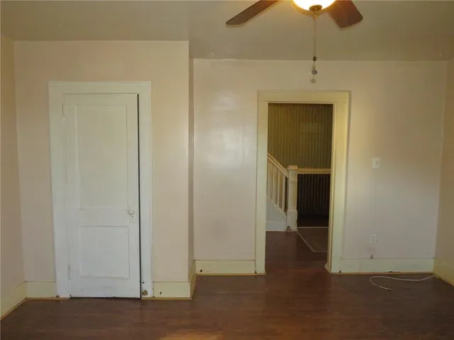an empty room with a empty space and chandelier fan