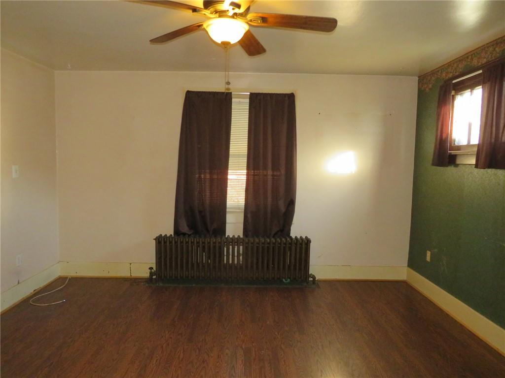 20 Beech Street Ambridge, PA 15003 - Photo 14 of 44 an empty room with wooden floor and fan