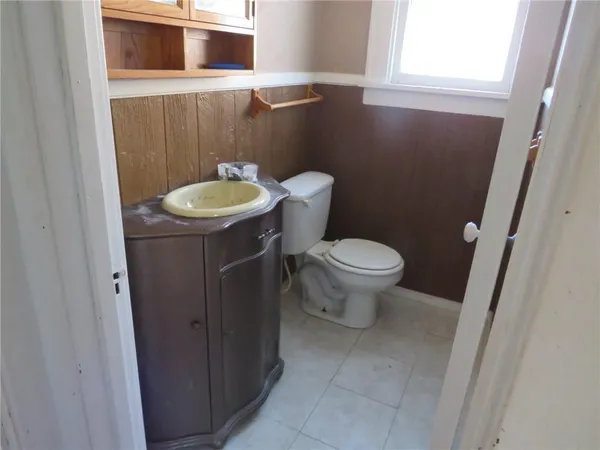 a view of hallway with a chair and a door