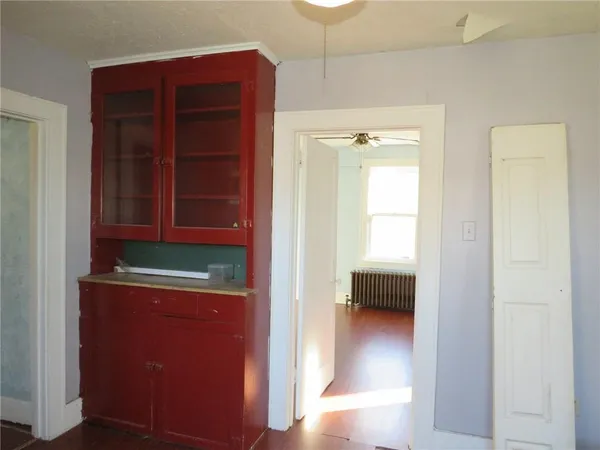 a room with cabinet and a window