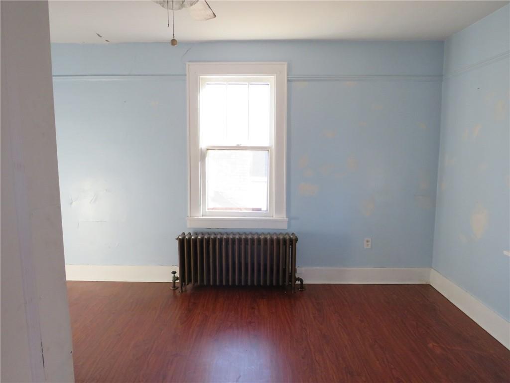 20 Beech Street Ambridge, PA 15003 - Photo 32 of 44 an empty room with wooden floor and windows