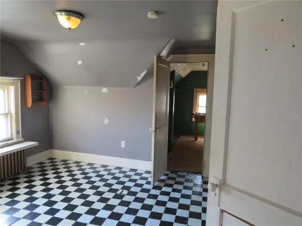 a view of a room with a large window and front door