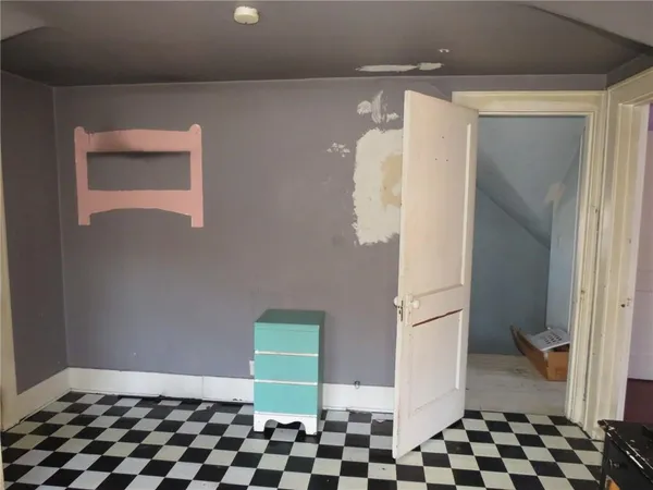a bathroom with a black and white checkered floor