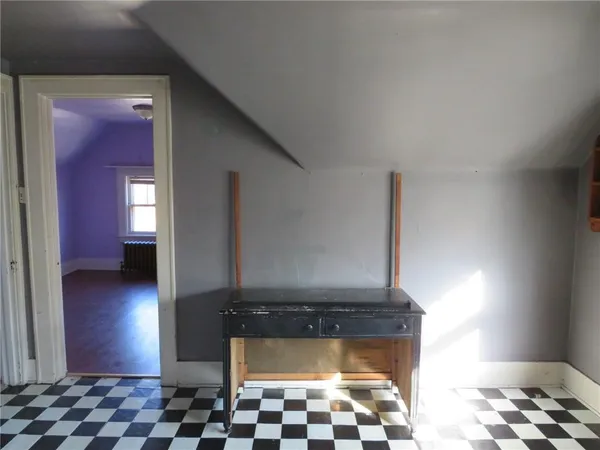a living room with a chair and a fireplace