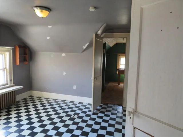 a view of a room with a large window and front door