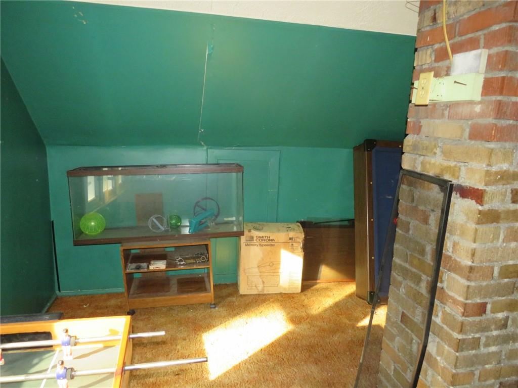 20 Beech Street Ambridge, PA 15003 - Photo 42 of 44 a living room with a chair and a fireplace