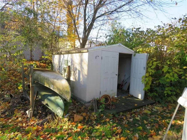 a view of backyard with outdoor seating and trees