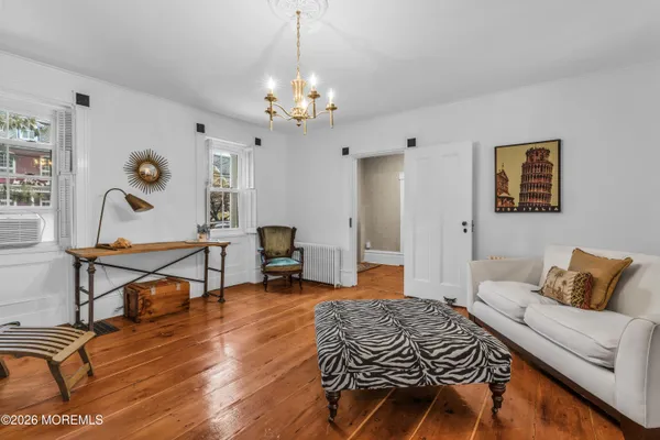a bedroom with furniture and a chandelier