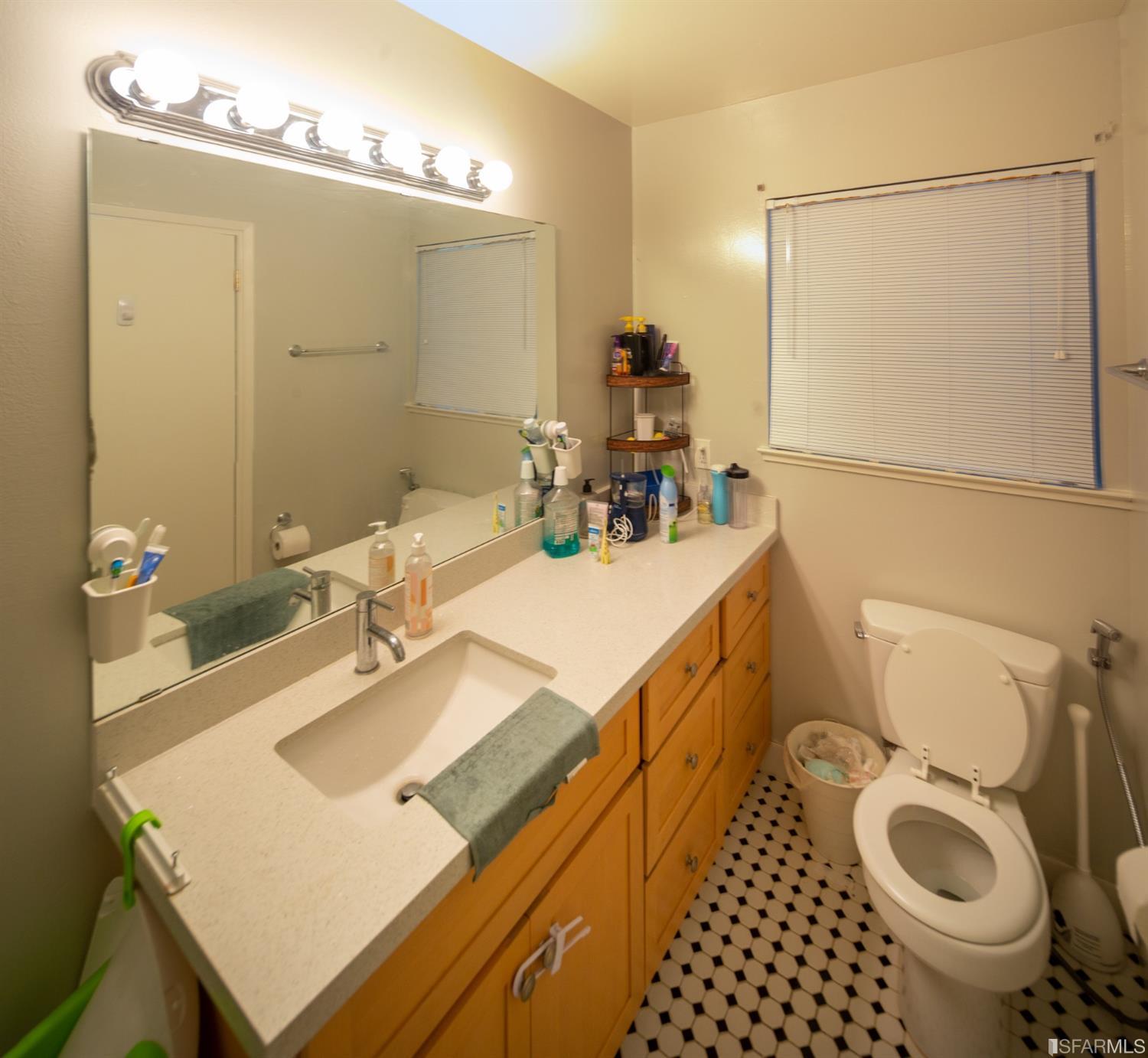 1455 Bay Street Alameda, CA 94501 - Photo 16 of 39 a bathroom with a sink toilet and a mirror
