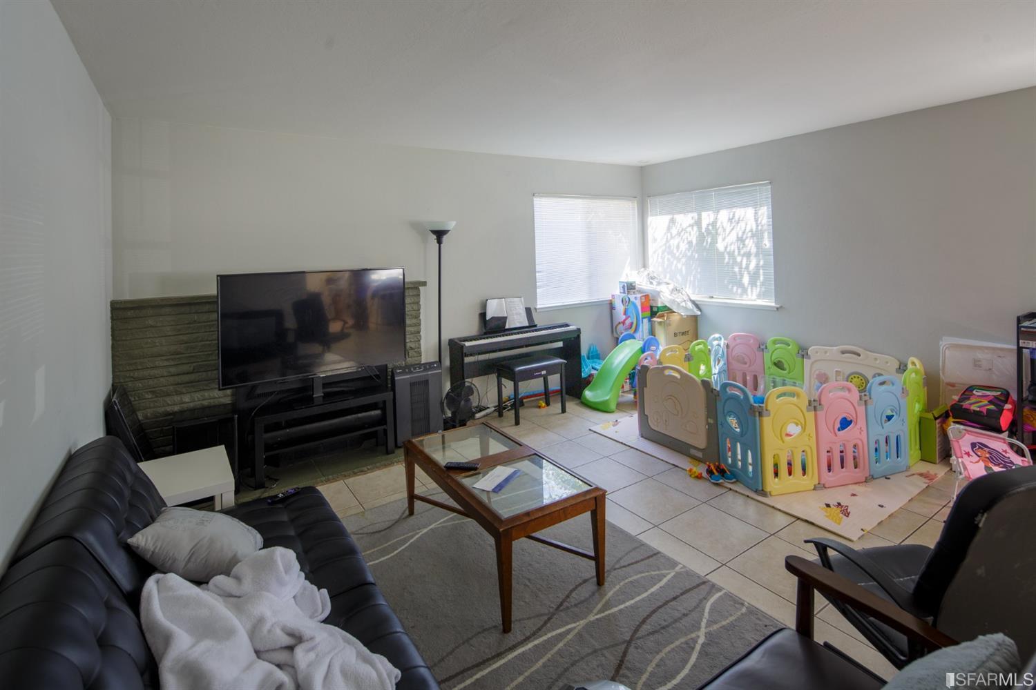 1455 Bay Street Alameda, CA 94501 - Photo 24 of 39 a living room with furniture fireplace and a window