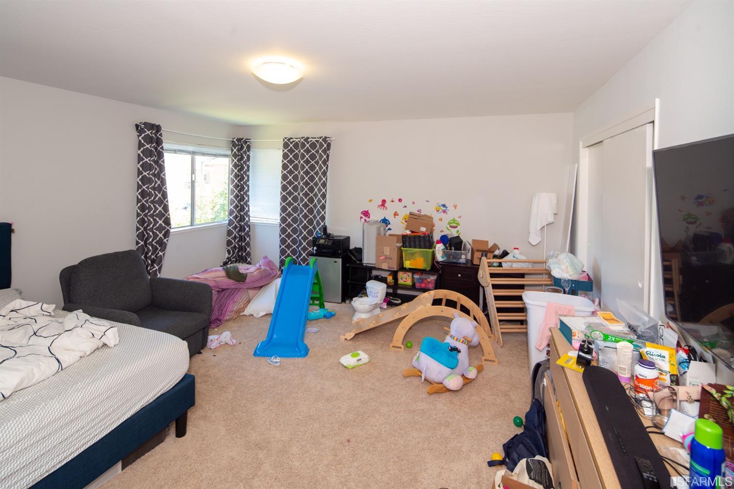 1455 Bay Street Alameda, CA 94501 - Photo 31 of 39 a bedroom with furniture and a flat screen tv