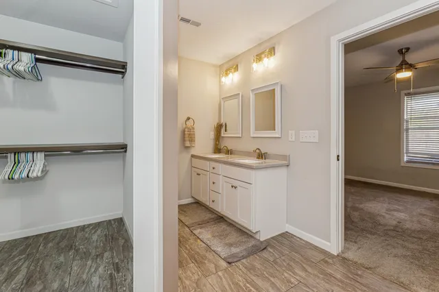 a bathroom with a double vanity sink and a mirror