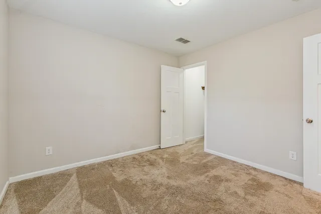 a bedroom with a bed and a potted plant