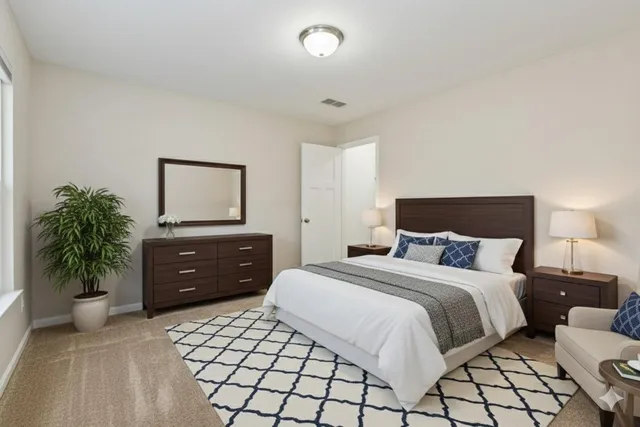 a view of an empty room with closet and a window
