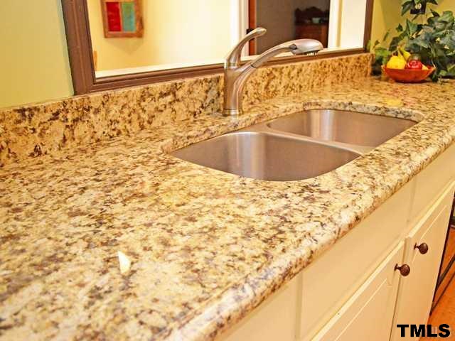 3625 Mill Run, Unit 5 Raleigh, NC 27612 - Photo 9 of 22 a bathroom with a sink and a mirror