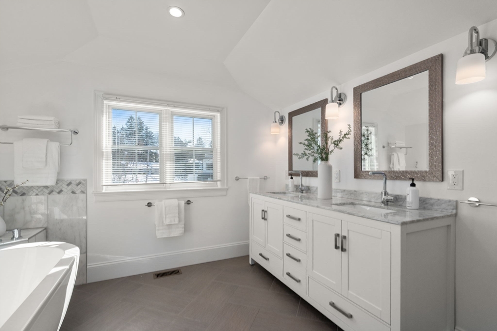 150 Country Club Road Newton, MA 02459 - Photo 17 of 33 a bathroom with a granite countertop sink mirror and a bathtub