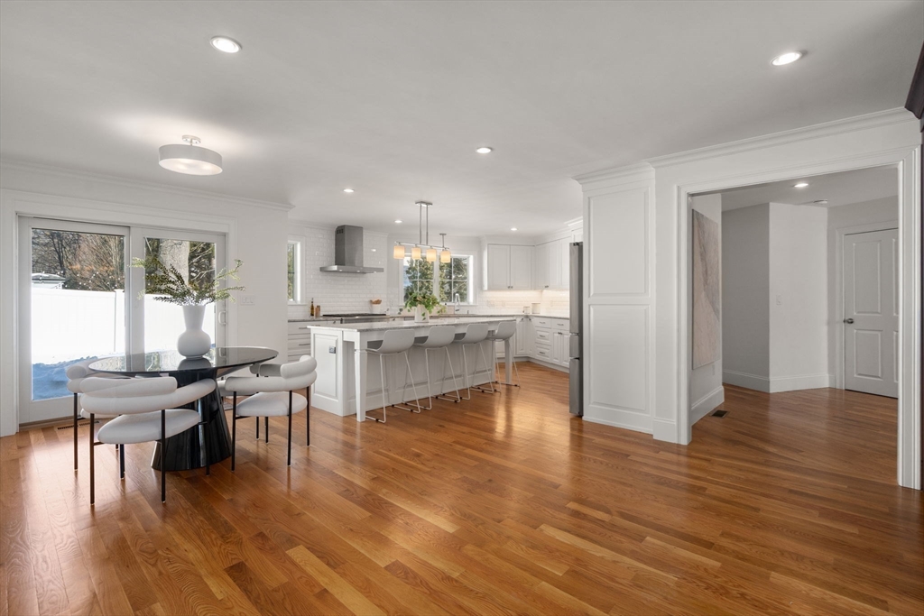 150 Country Club Road Newton, MA 02459 - Photo 6 of 33 an open kitchen with white cabinets and stainless steel appliances