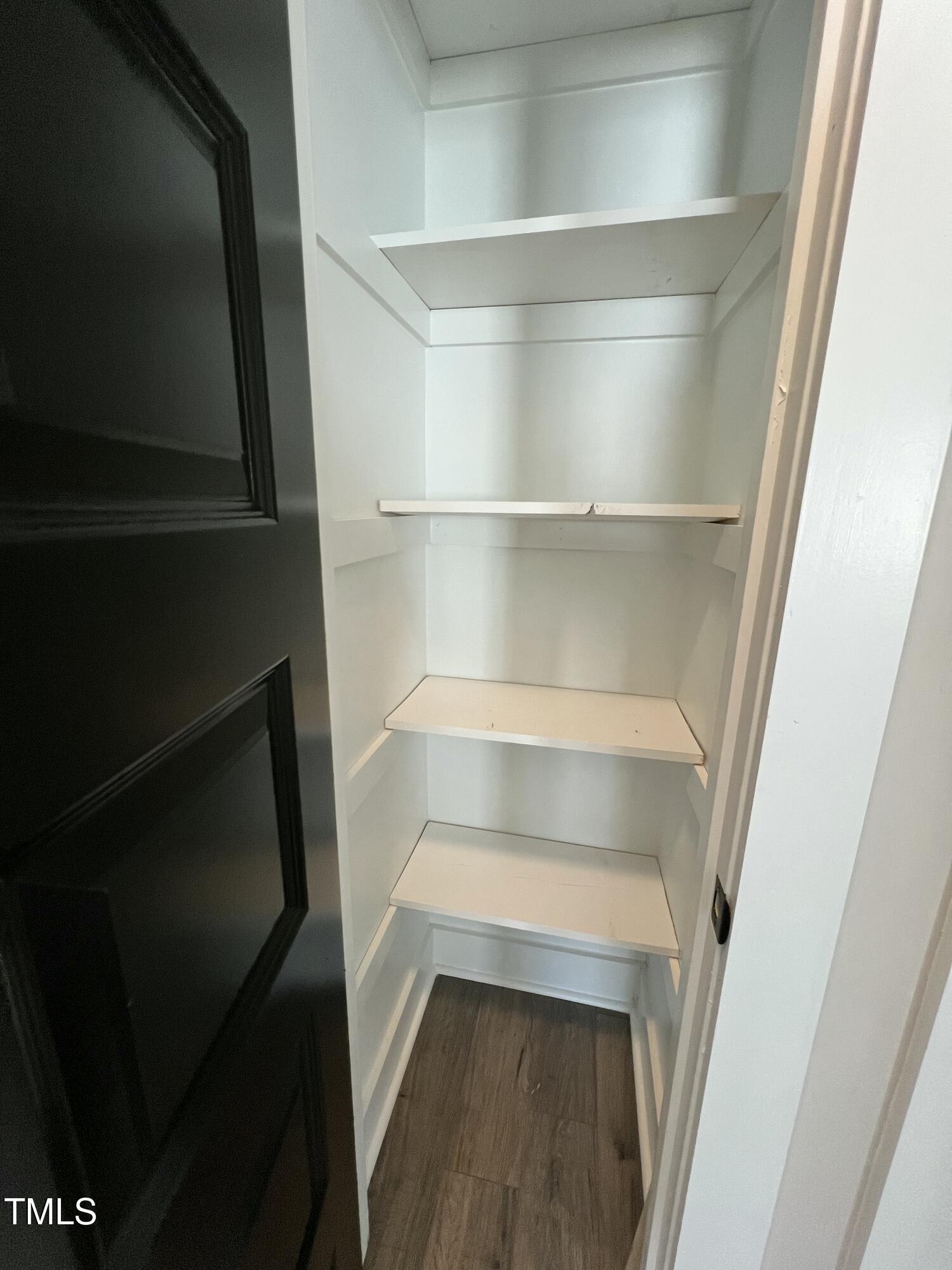 151 East Washington Street Coats, NC 27521 - Photo 15 of 44 a view of walk in closet with empty racks