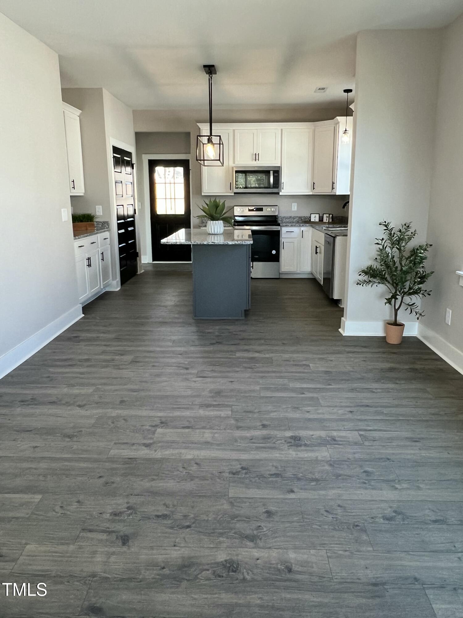 151 East Washington Street Coats, NC 27521 - Photo 8 of 44 a kitchen with stainless steel appliances kitchen island granite countertop a stove a sink and a refrigerator