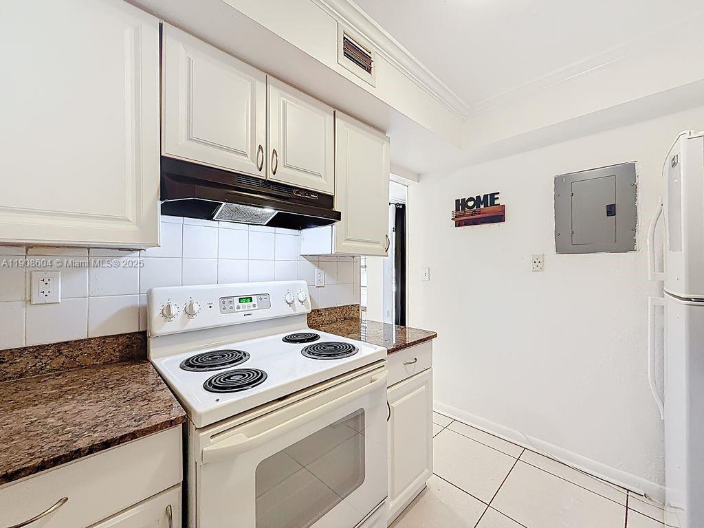 17600 Northwest 68th Avenue, Unit B2004 Hialeah, FL 33015 - Photo 15 of 24 a kitchen with granite countertop cabinets and white appliances