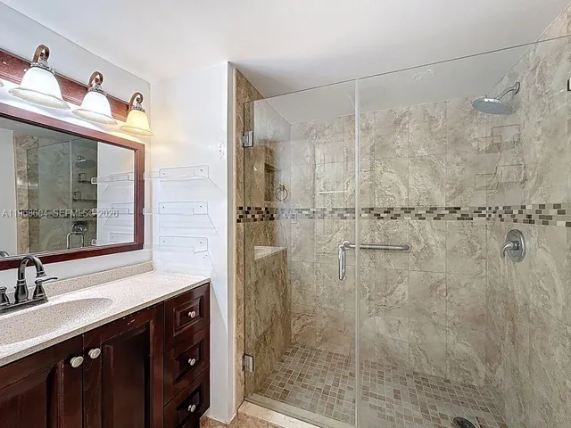 a bathroom with a shower and a sink