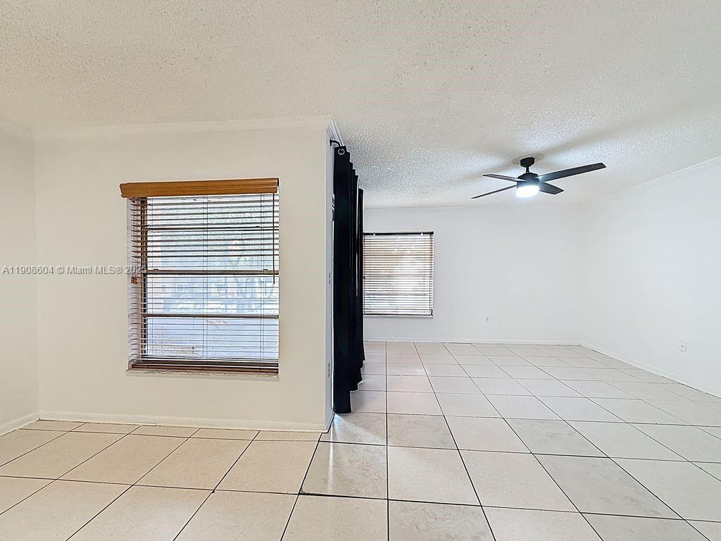 17600 Northwest 68th Avenue, Unit B2004 Hialeah, FL 33015 - Photo 9 of 24 a view of an empty room with a window