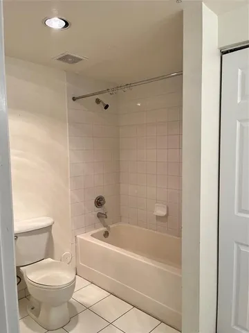 a bathroom with a bathtub and a toilet