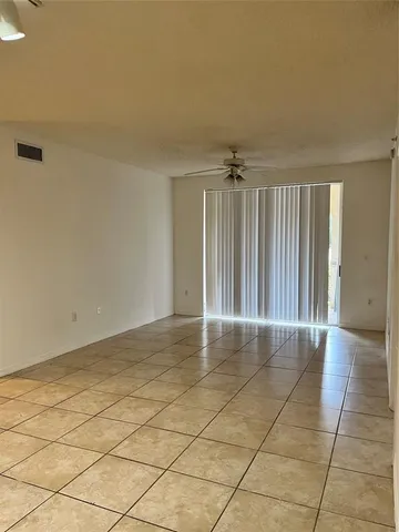 a view of an empty room and wooden floor