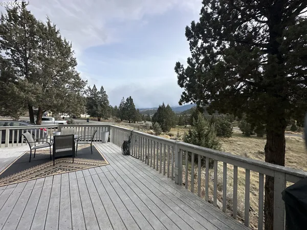 a view of roof deck with wooden floor and fence