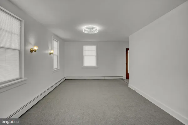an empty room with a empty space and windows