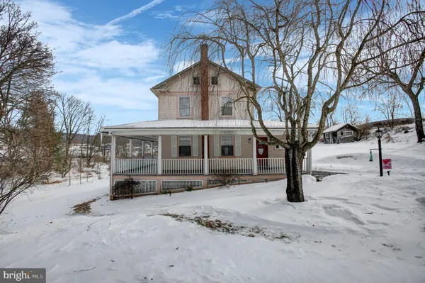 a front view of a house with a yard covered in snow