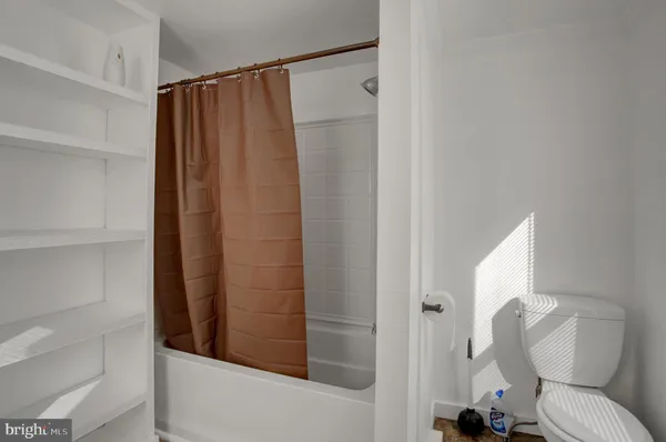 a bathroom with a toilet and a shower