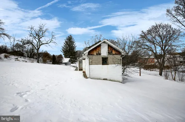 a view of white house with a yard covered in snow