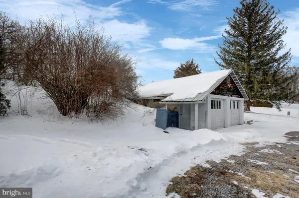 a view of a house with a snow in the yard
