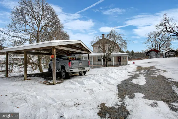 a view of a house with a snow in the yard