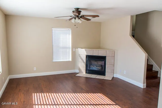 a view of an empty room with a fireplace and a window