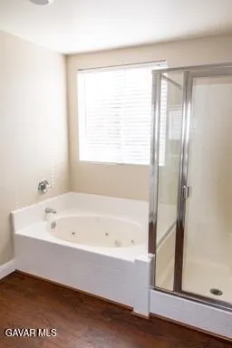 a bathroom with a bathtub and a shower