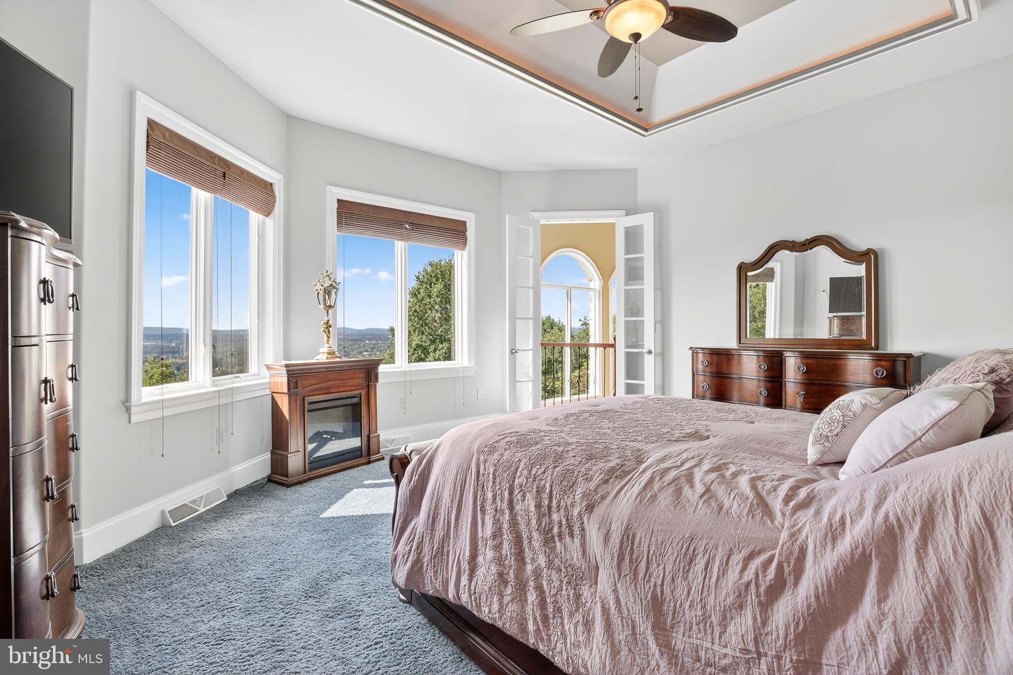 522 Halyard Way Enola, PA 17025 - Photo 43 of 60 a bedroom with a large bed and a chandelier next to a window