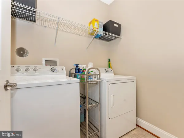 a bathroom with a double vanity sink toilet and a mirror