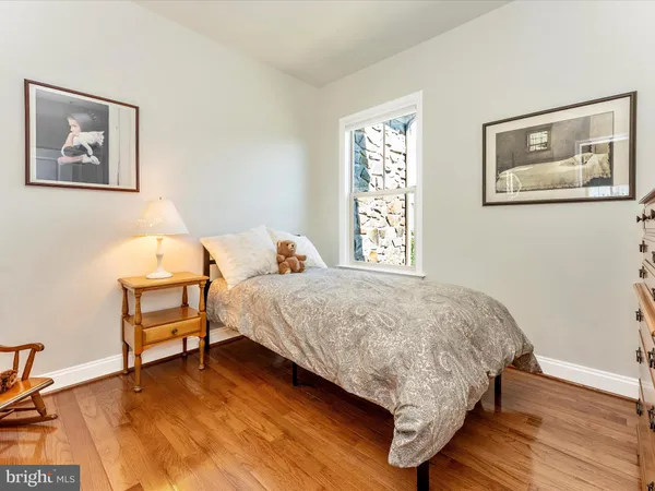 a bedroom with furniture and a wooden floor