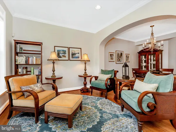 a living room with furniture a rug and a chandelier