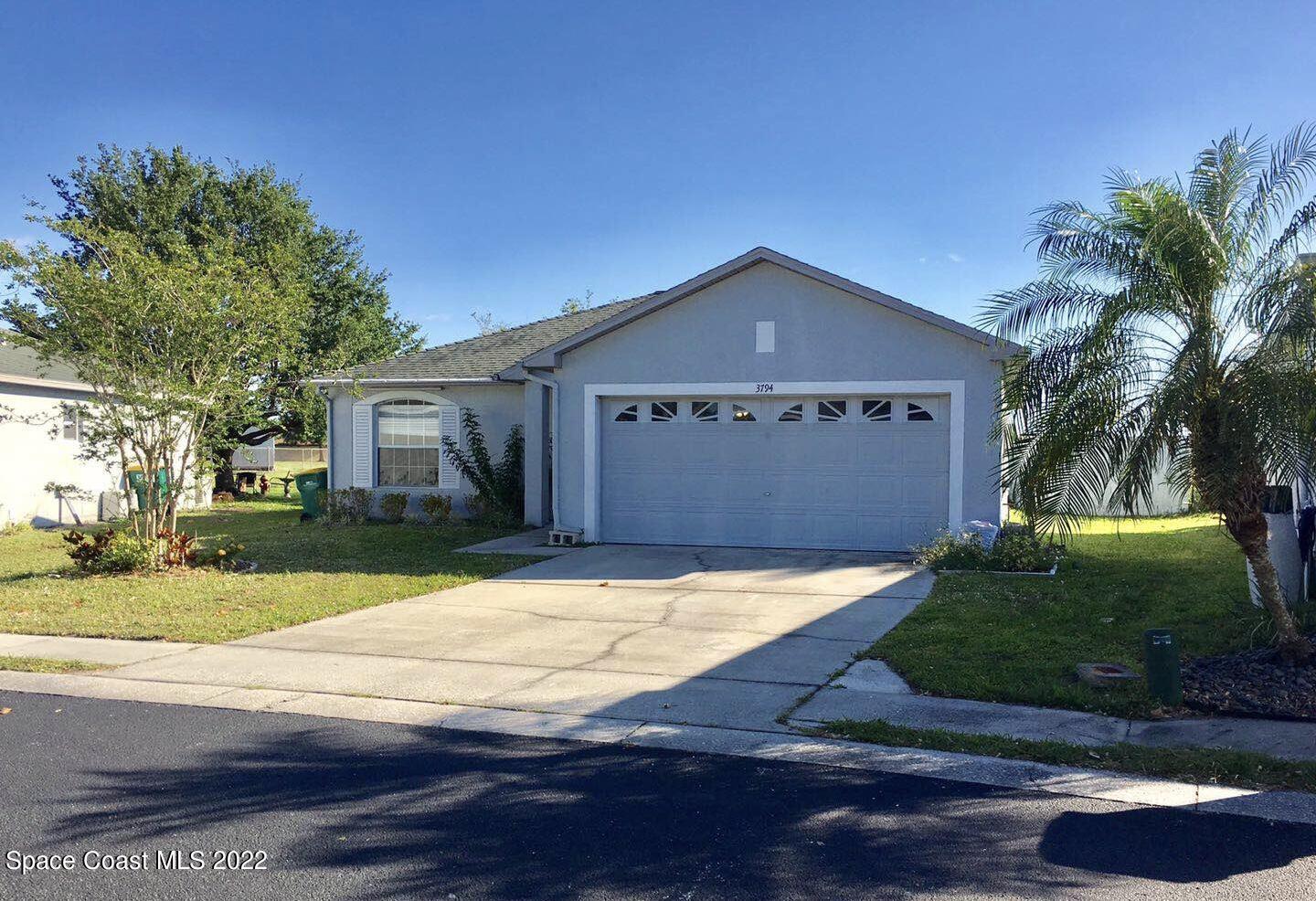 3794 Town Square Boulevard Melbourne, FL 32901 - Photo 1 of 18 a front view of a house with a yard