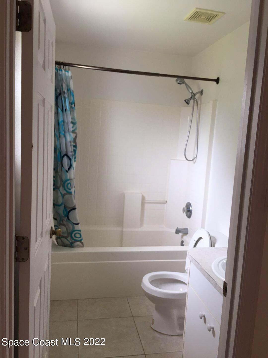 3794 Town Square Boulevard Melbourne, FL 32901 - Photo 14 of 18 a bathroom with a shower a toilet and a shower