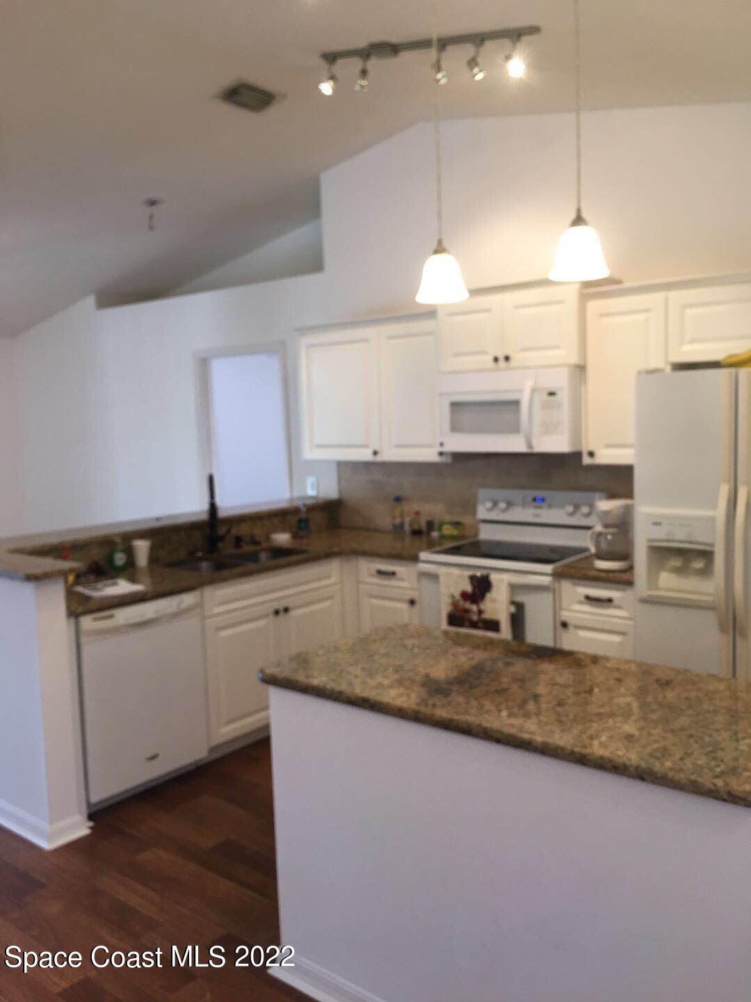 3794 Town Square Boulevard Melbourne, FL 32901 - Photo 5 of 18 a kitchen with stainless steel appliances granite countertop a sink stove and refrigerator