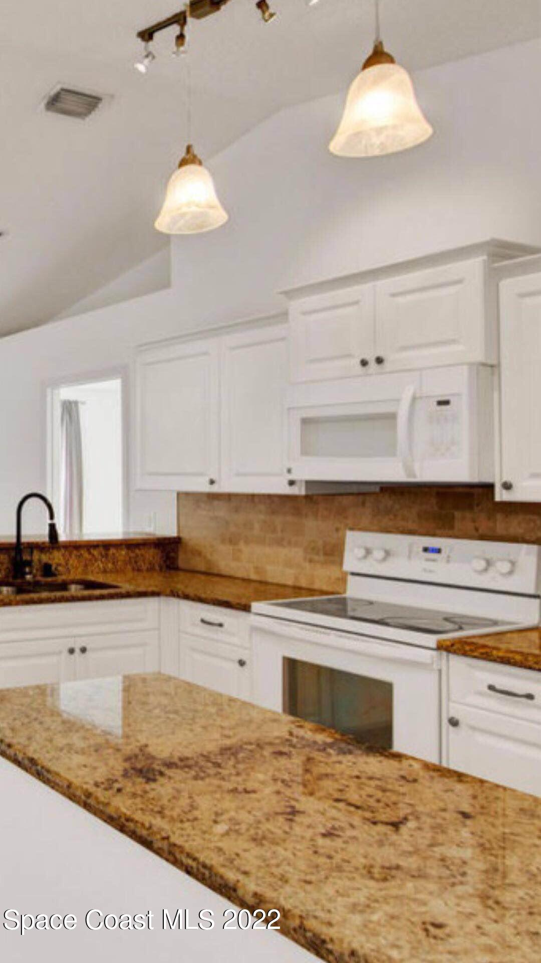 3794 Town Square Boulevard Melbourne, FL 32901 - Photo 9 of 18 a kitchen with stainless steel appliances granite countertop a sink and a stove