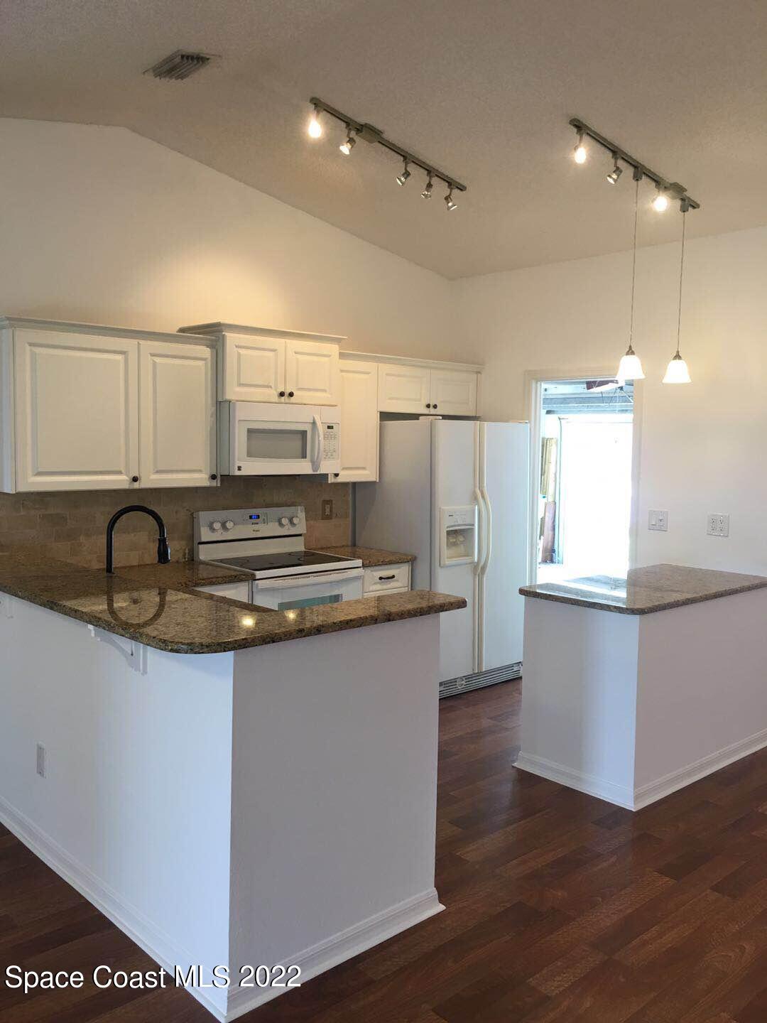 3794 Town Square Boulevard Melbourne, FL 32901 - Photo 10 of 18 a kitchen with stainless steel appliances granite countertop a sink stove and refrigerator