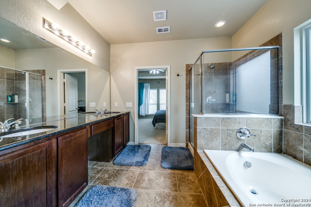 3113 Cameron River Schertz, TX 78108 - Photo 17 of 24 a large bathroom with a tub a sink and mirrors