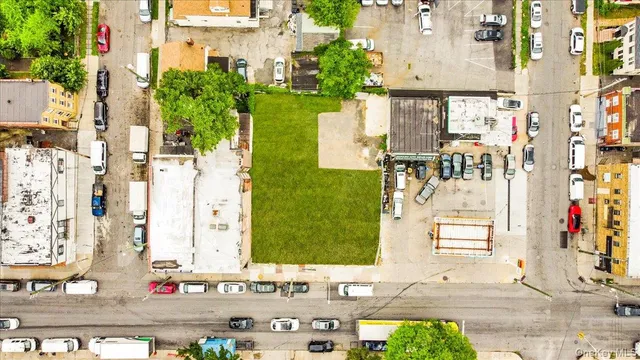 an aerial view of residential houses with outdoor space and parking