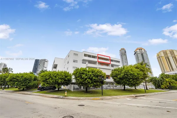 a view of a tall building next to a road